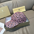 Burberry cap with pink and black monogram pattern, curved brim and side profile view