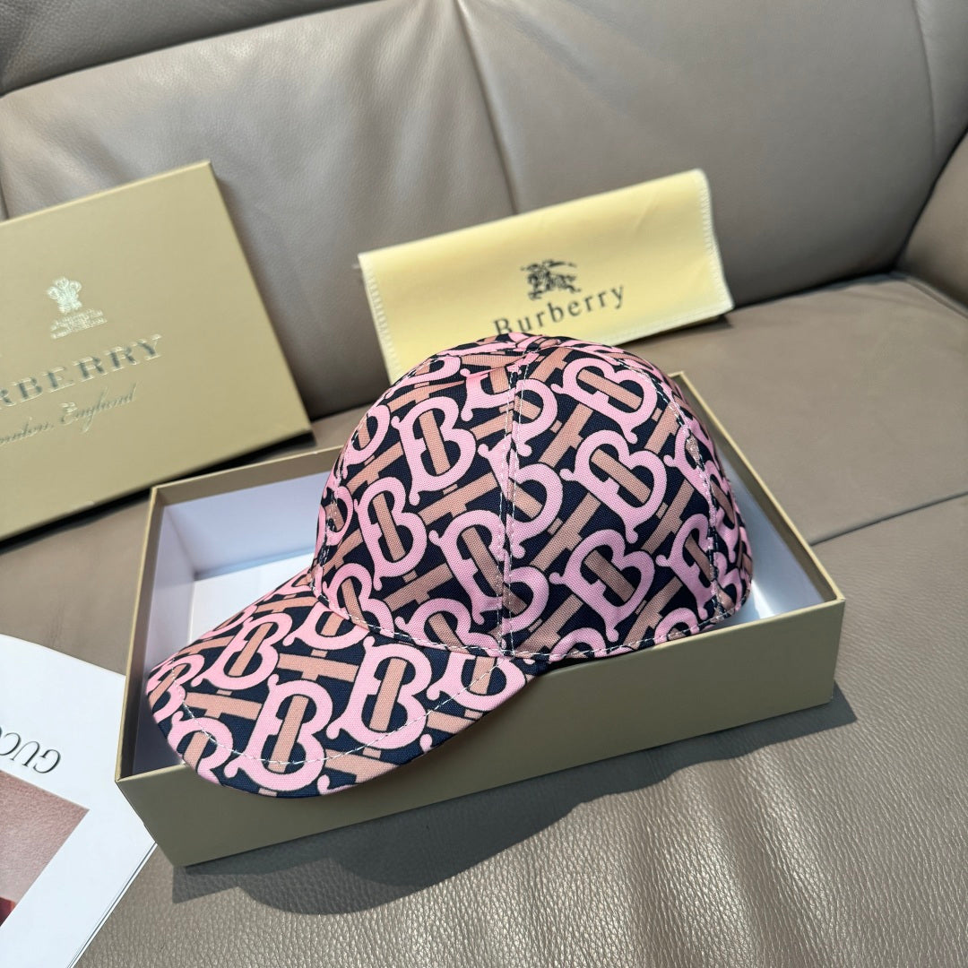 Burberry cap with pink and black monogram pattern, curved brim and side profile view