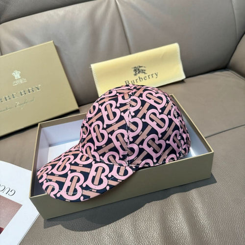 Burberry cap with pink and black monogram pattern, curved brim and side profile view