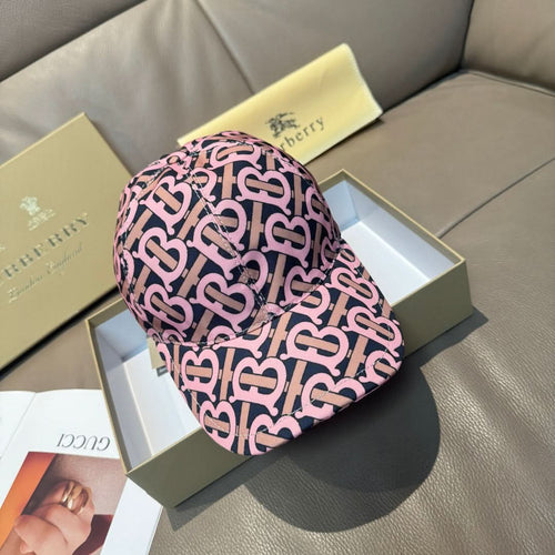 Burberry cap with pink and black monogram pattern, curved brim and stitched crown seams