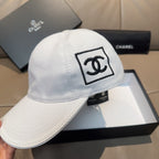 White baseball cap with large embroidered Chanel CC logo patch