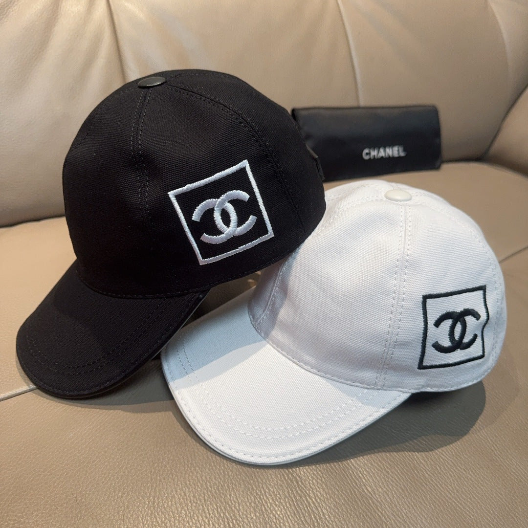 Chanel baseball caps in black and white, each with CC logo patch