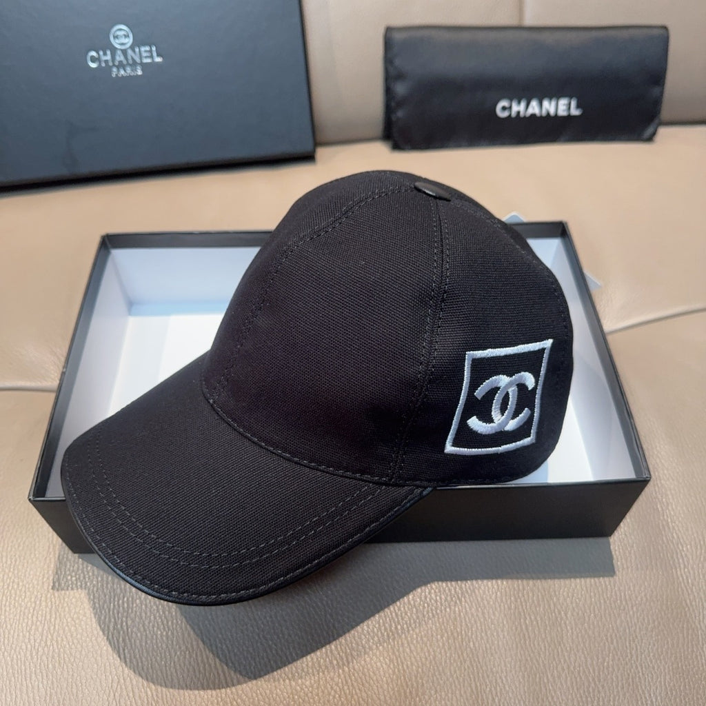 Black Chanel logo baseball cap with curved brim and stitched crown