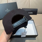 Black Chanel cap underside with adjustable strap and CHANEL fabric label