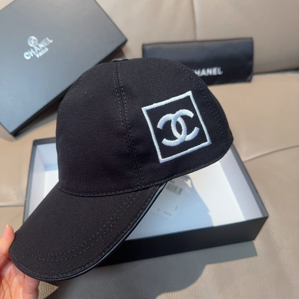 Black Chanel cap with front CC logo patch and curved brim