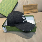 Black Gucci baseball cap with GG monogram pattern and white GG logo at front.