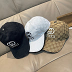 Three Gucci baseball caps: black, white, and tan, each with GG monogram and logo.