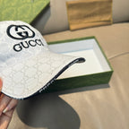 White Gucci baseball cap close-up of side, GG pattern and front logo
