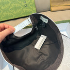 White Gucci baseball cap underside view with black lining and hanging tags