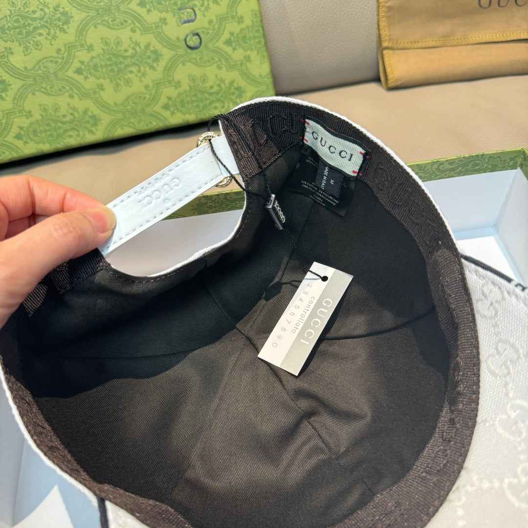 White Gucci baseball cap underside view with black lining and hanging tags