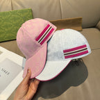 Pink and white Gucci GG-pattern baseball caps with magenta striped webbands
