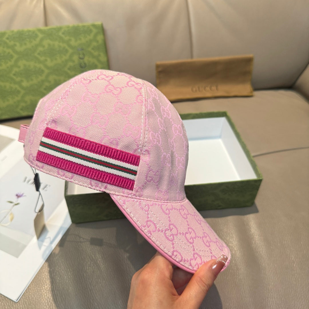 Pink Gucci GG-pattern cap with magenta, white, and black striped band