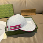 White logo baseball cap with magenta striped band, side angle
