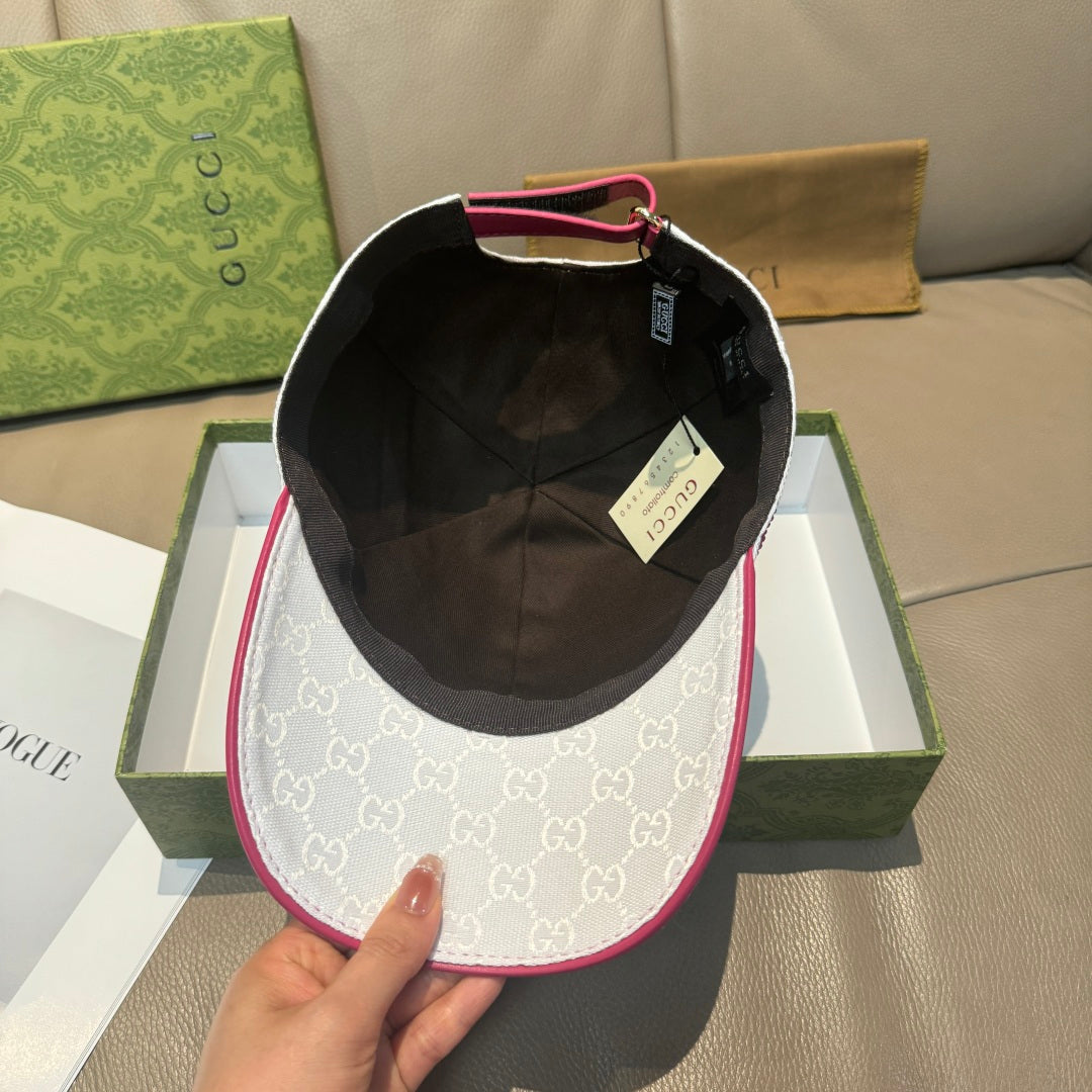 White logo baseball cap with black interior lining and magenta trim