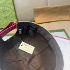 White logo baseball cap with black interior and magenta strap, brand tags inside