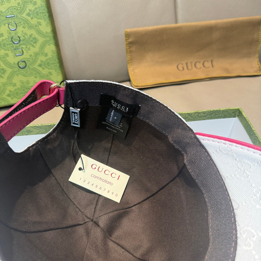 White logo baseball cap with black interior and magenta strap, brand tags inside
