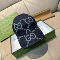 Gucci cap, dark navy denim with light blue GG monogram pattern and curved brim.