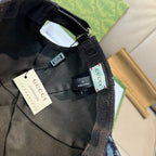 Gucci cap interior with black strap and tags, dark navy denim GG print.