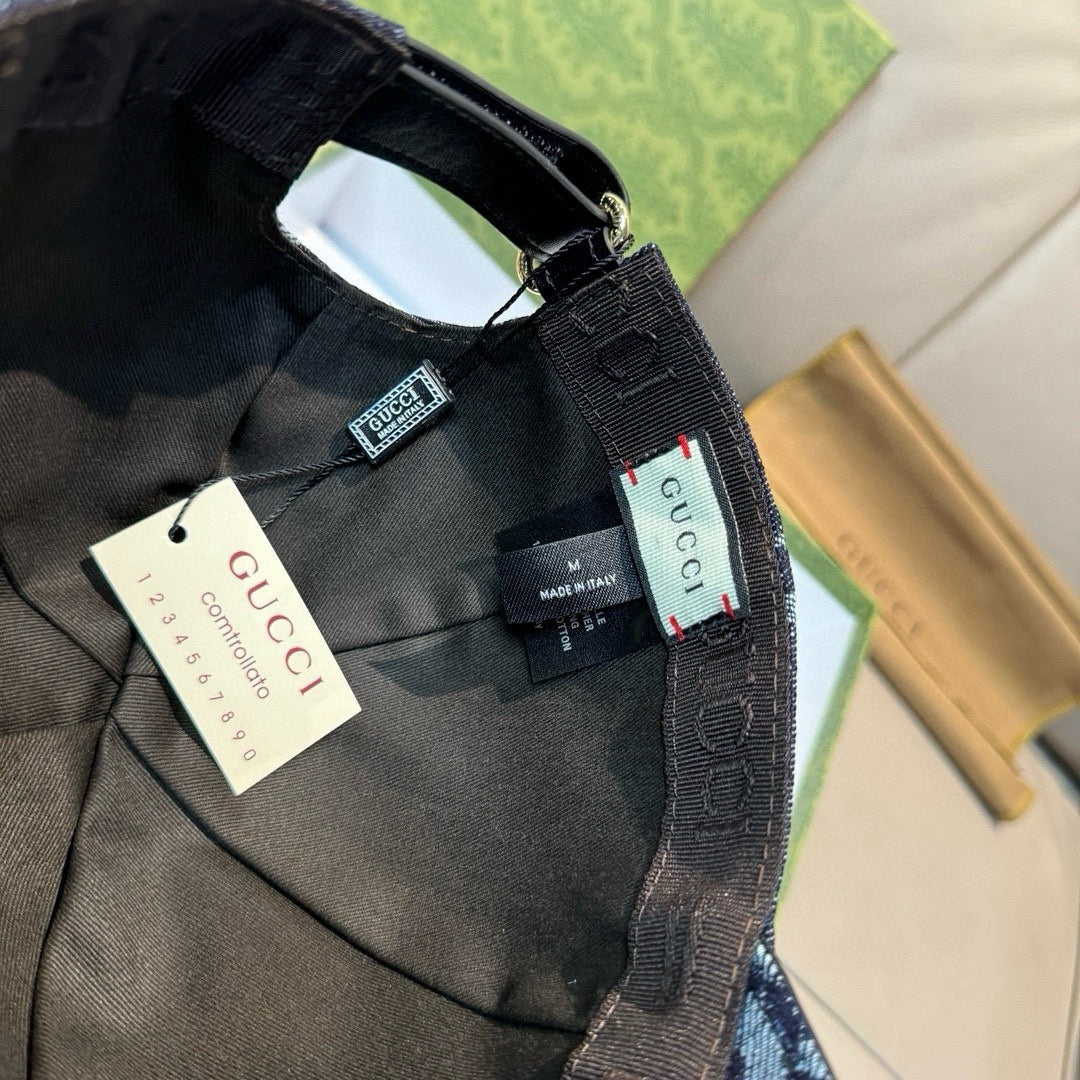 Gucci cap interior with black strap and tags, dark navy denim GG print.