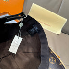 Louis Vuitton cap with adjustable strap and tags, monogram brim visible.