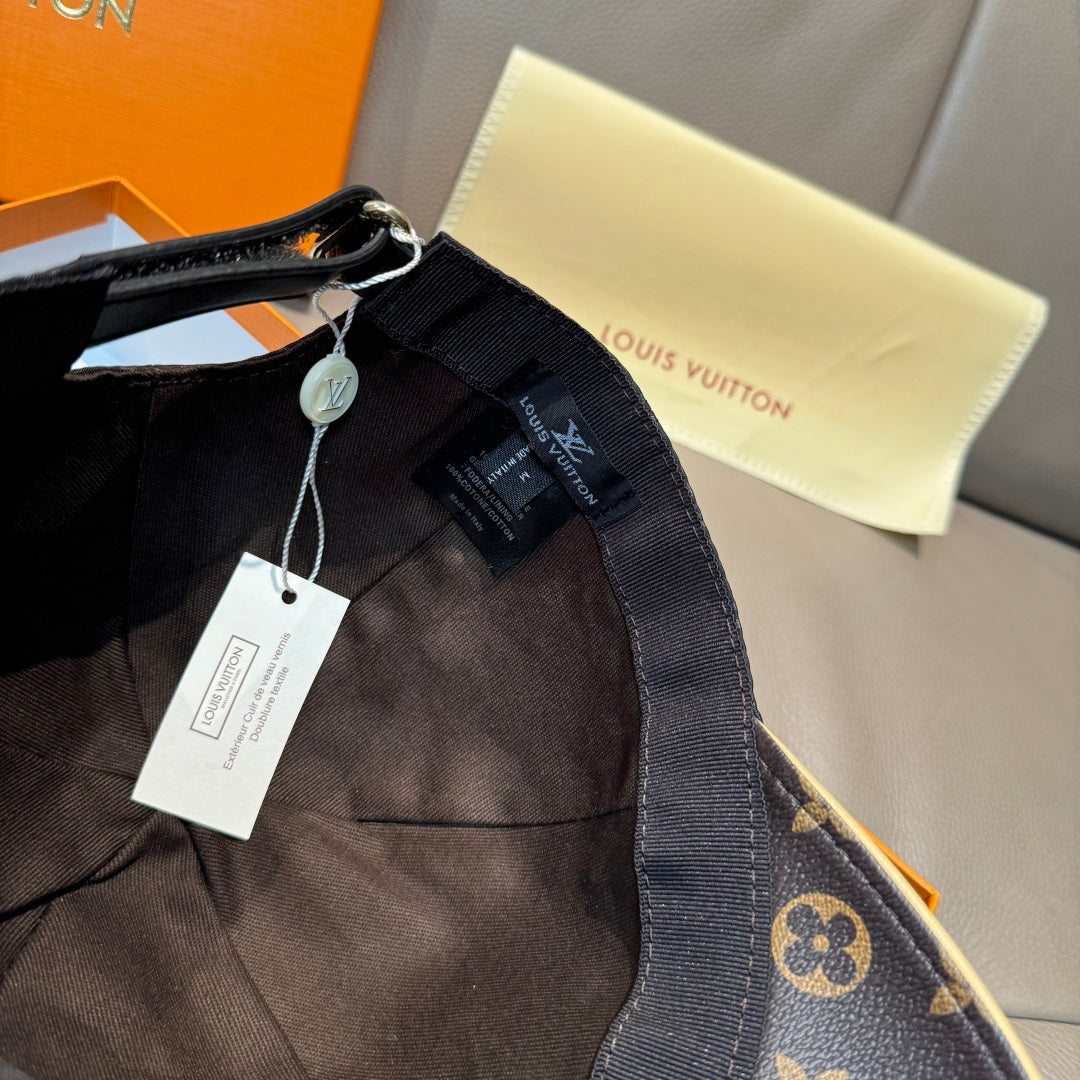 Louis Vuitton cap with adjustable strap and tags, monogram brim visible.