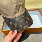 Front view of two-tone monogram cap with LV logo and curved brim