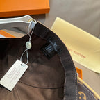 Black monogram cap interior with hanging tag and strap detail