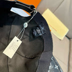 Louis Vuitton monogram cap strap and tags on dark fabric, adjustable closure