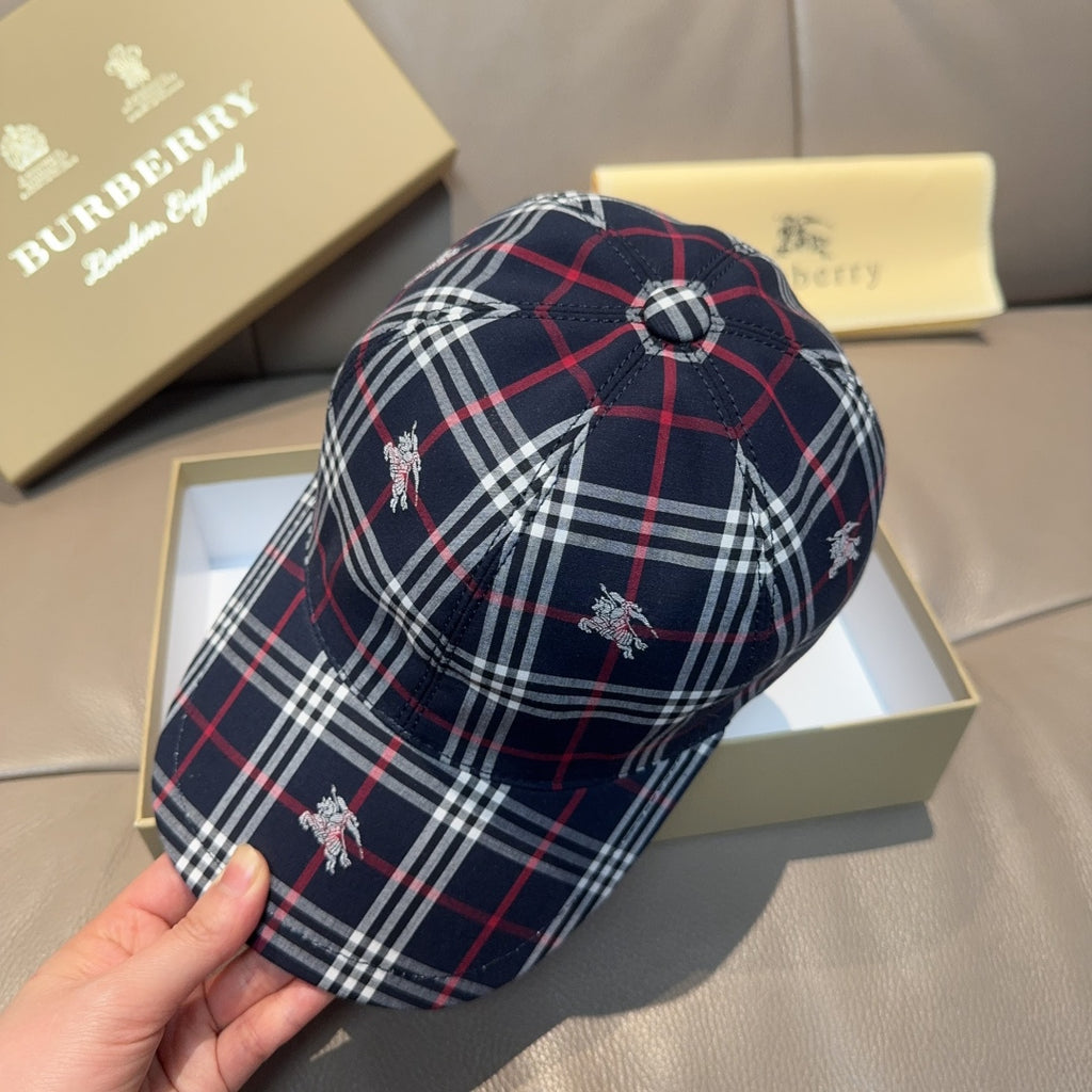 Plaid baseball cap in navy with red and white checks, buttoned crown and embroidered motifs.