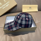 Plaid baseball cap in navy with red and white lines, embroidered motifs on crown.