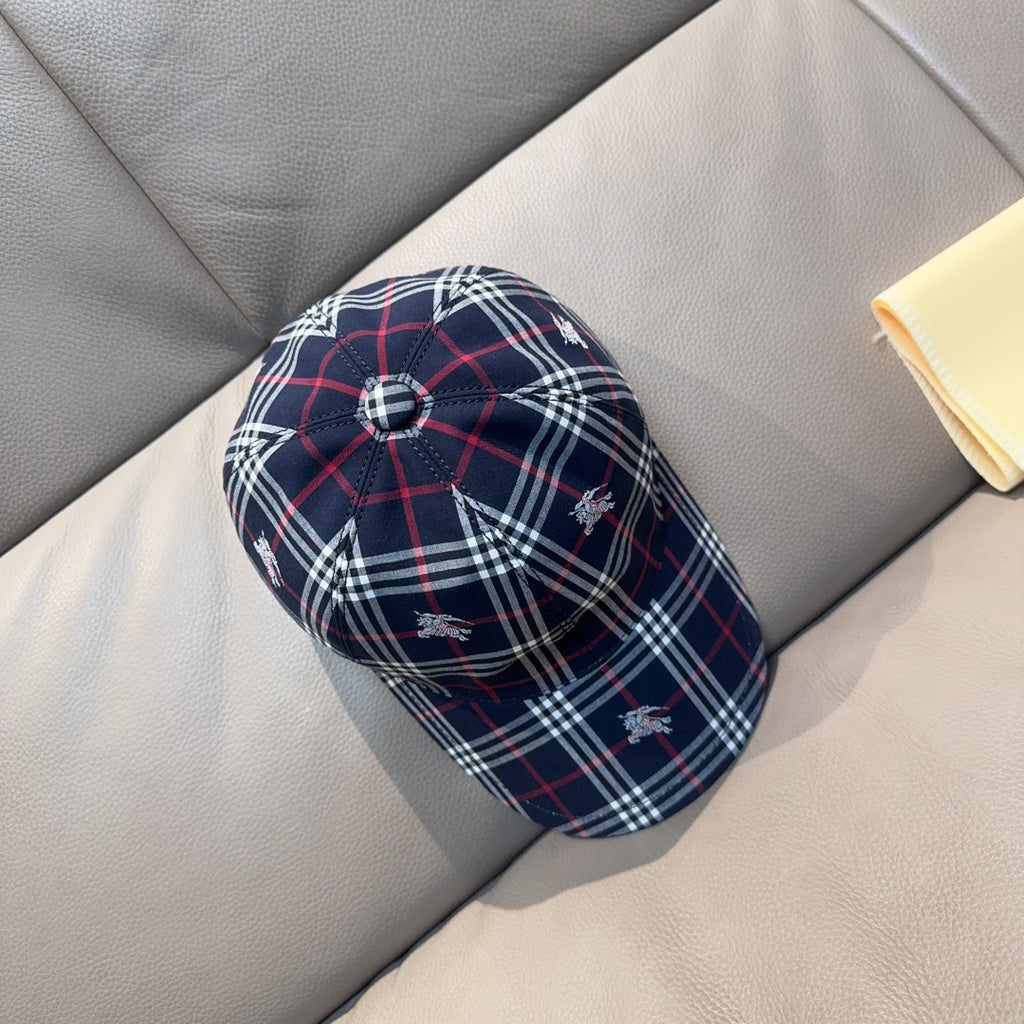 Plaid baseball cap in navy with red and white checks, small embroidered motifs.