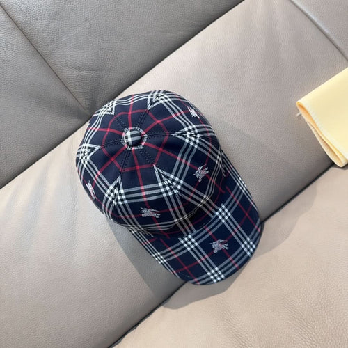 Plaid baseball cap in navy with red and white checks, small embroidered motifs.