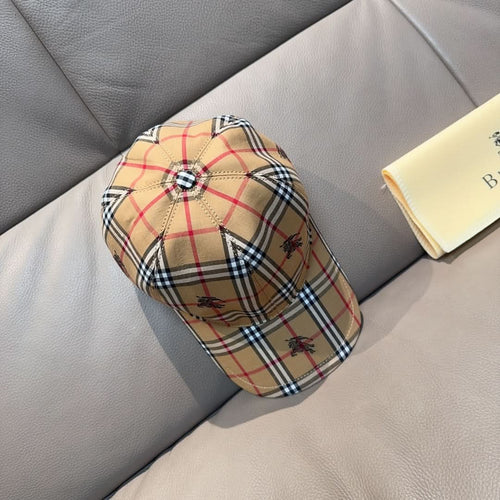 Burberry plaid baseball cap in beige with red and navy accents, buttoned top and brim
