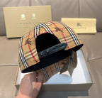 Beige plaid Burberry cap with black interior strap and metal eyelets, curved brim
