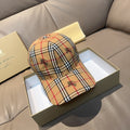 Burberry cap in beige, red, and navy plaid with embroidered motifs and curved brim