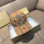 Burberry cap in beige, red, and navy plaid with embroidered motifs and curved brim