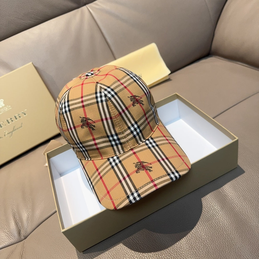Burberry cap in beige, red, and navy plaid with embroidered motifs and curved brim