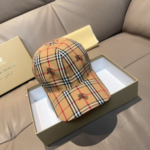 Burberry cap in beige, red, and navy plaid with embroidered motifs and curved brim
