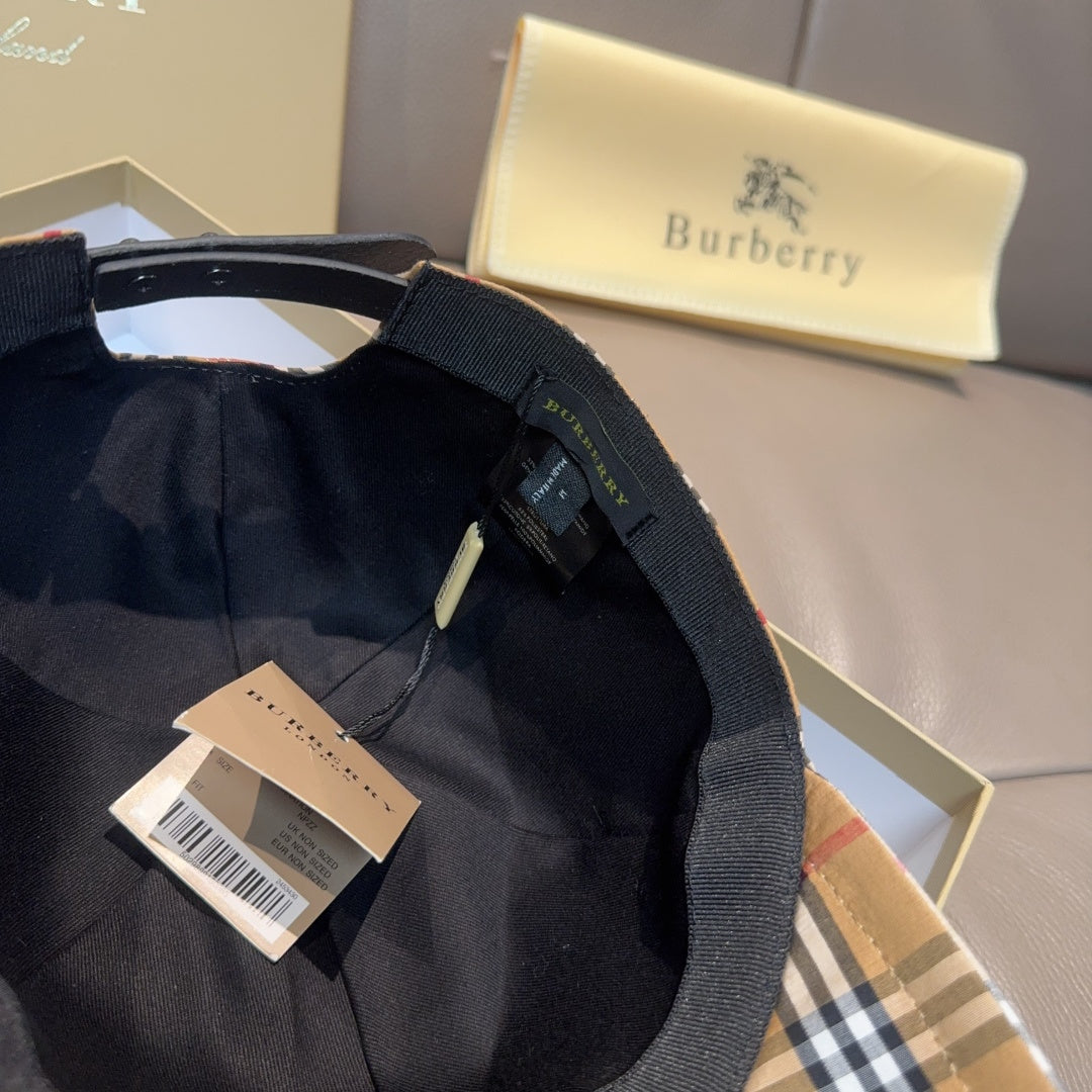 Navy Burberry cap in fabric with adjustable strap and white product tag in the box