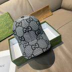 Grey baseball cap with black GG pattern, curved brim and top button