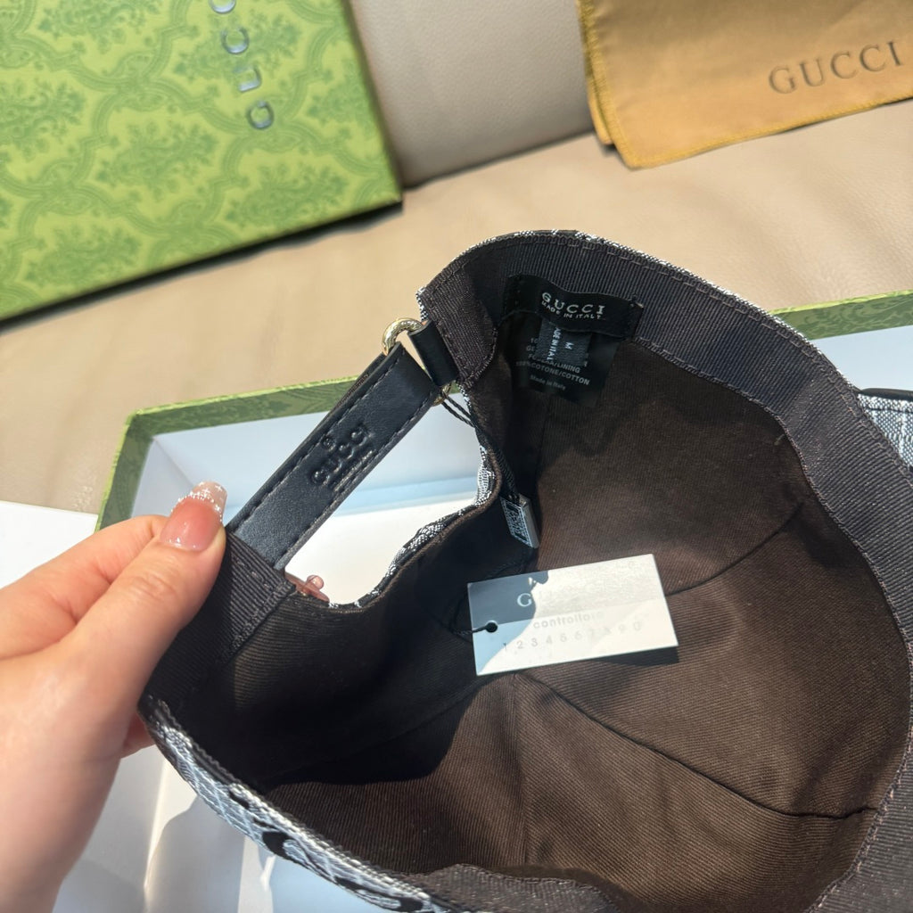 Dark interior of grey GG baseball cap with adjustable strap and hanging tags