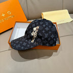 Louis Vuitton baseball cap in dark navy with monogram pattern and animal patch on front.