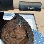 Blue denim cap with white dot and logo pattern, shown with neck strap and tag