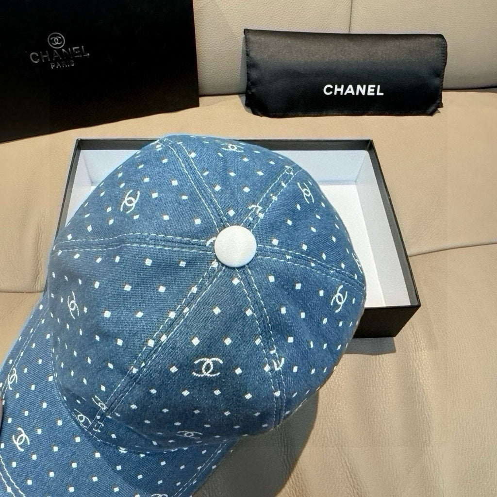 Blue denim baseball cap top view with round button and white dot and logo pattern