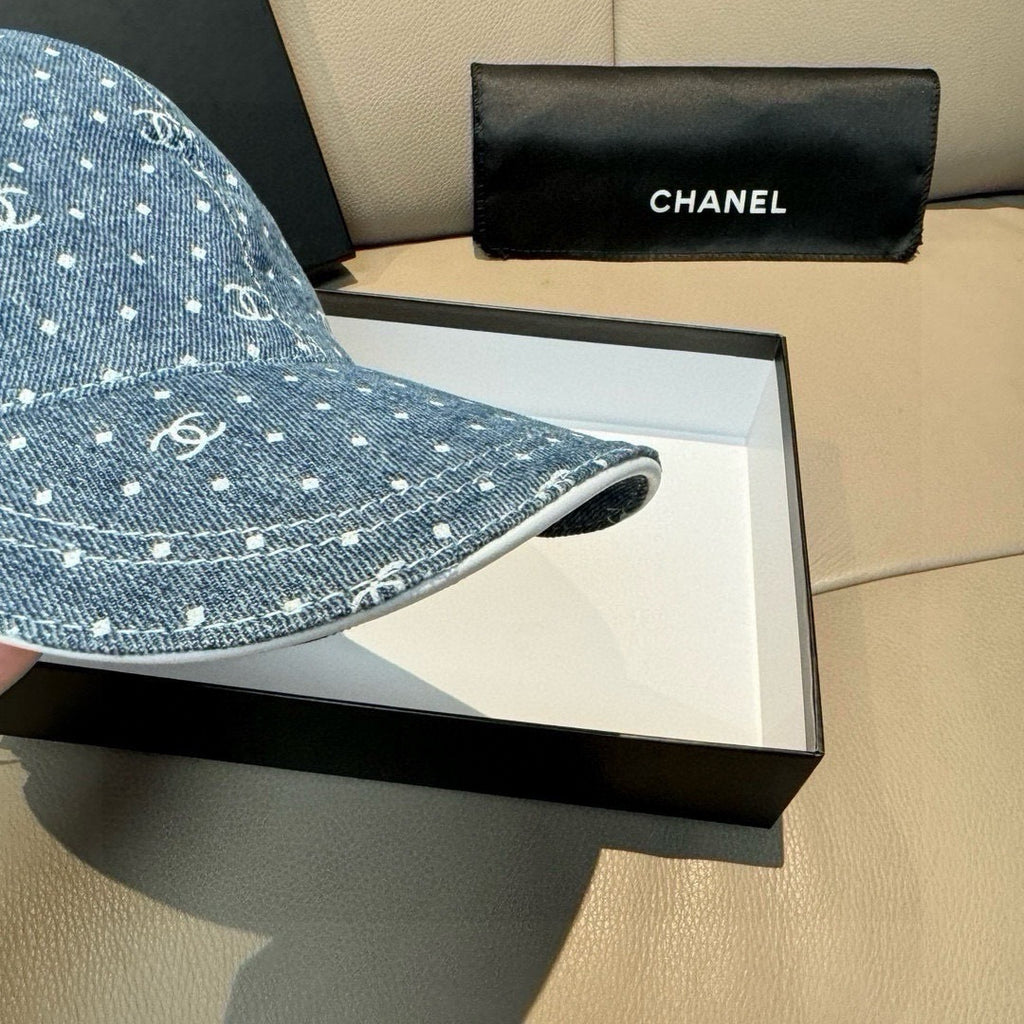 CHANEL blue denim cap brim close-up with white dot CC logo pattern