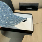 CHANEL blue denim cap brim close-up with white dot CC logo pattern
