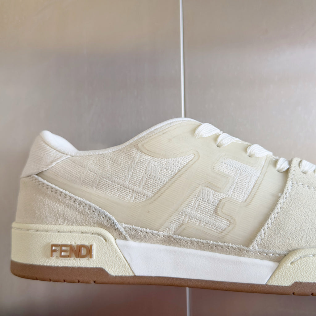 Cream low-top lace-up sneaker detail with FENDI logo patch on side