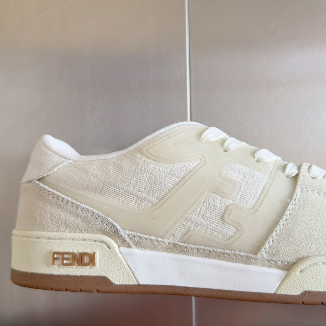 Cream low-top lace-up sneaker detail with FENDI logo patch on side