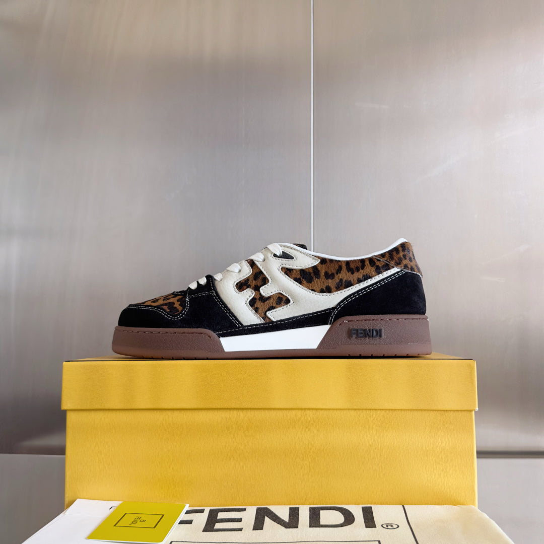 Low-top Fendi sneakers on a yellow box: leopard print panels with dark navy and white trim