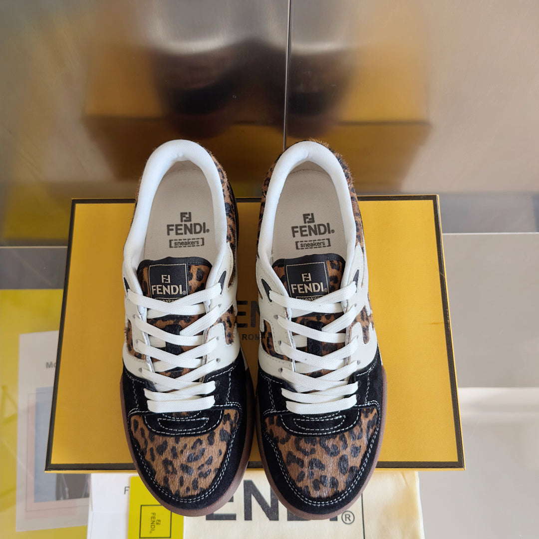Pair of unisex Fendi sneakers with white laces, leopard print panels, and navy toe caps